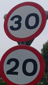 A 30 miles per hour speed limit sign immediately above a 20 miles per hour one